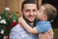 Happy dad with his little sun outdoors. Sun kiss his father cheek Royalty Free Stock Photo