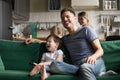 Happy dad and kid son laughing watching tv together Royalty Free Stock Photo