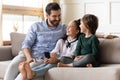 Happy dad and kids use cellphone relaxing at home Royalty Free Stock Photo