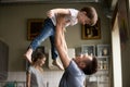 Happy dad lifting son having fun playing together at home Royalty Free Stock Photo