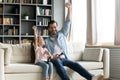 Happy dad and little daughter play computer game together