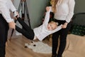 Happy dad and mom swing their daughter in their arms. Royalty Free Stock Photo