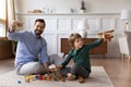 Happy dad play toys with little son at home Royalty Free Stock Photo