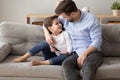 Happy dad and preschooler son relax on couch together Royalty Free Stock Photo