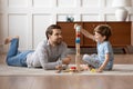Happy dad and small son play with wooden blocks Royalty Free Stock Photo