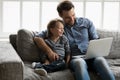 Happy daddy and adorable gen Z boy sitting together