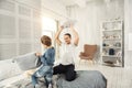 Happy daddy and son having a pillow fight Royalty Free Stock Photo