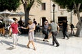 Happy dancer couples are dancing Swing and Rock and Roll dances at a street in Elche city, Spain