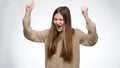 Happy dancing and cheering girl laughing and smile because of success or victory over white studio background