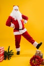 Happy dancing Santa Claus with hands on his waist extending leg Royalty Free Stock Photo