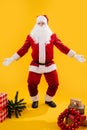 Happy dancing Santa Claus squating with hands and knees apart, like shrugging Royalty Free Stock Photo