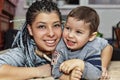 A happy dark-skinned mother with her little son plays and laughs Royalty Free Stock Photo