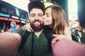 Happy dating couple in love taking selfie photo on Times Square in New York while travel in USA on honeymoon Royalty Free Stock Photo