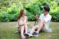 Happy dating couple outdoor picnic with camera