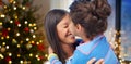 Happy daughter kissing her mother on christmas Royalty Free Stock Photo