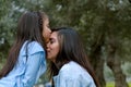 Happy daughter kissing her mother enjoying a winter afternoon Royalty Free Stock Photo