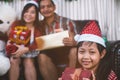 Happy daughter mother and father holding a gift box.Family in Christmas interior with vintage style Royalty Free Stock Photo