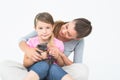 Happy daughter and mother sitting with pet kitten together Royalty Free Stock Photo