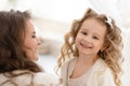 Happy daughter playing with mother. cute baby girl smiling and looking at the camera.