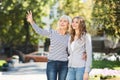 Happy daughter walking with senior mother in park Royalty Free Stock Photo