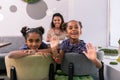 Two cute beaming daughters feeling happy seeing their father in restaurant