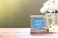 HAPPY DAY! coffee mug on wooden table with white aster flowers in vase Royalty Free Stock Photo