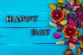 Happy day word on blue wood with flower Royalty Free Stock Photo