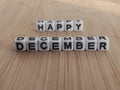 Happy December words on white blocks on a wood background