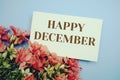 Happy December text with flower frame on blue background