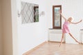 Happy delightful little thin girl jumping fun dancing indoors at home during self isolated quarantine