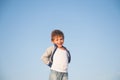 Happy delightful smiling little boy in sweater on blue sky background Royalty Free Stock Photo