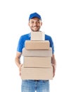 Happy delivery man in blue uniform holding pile of cardboard box