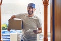 Happy delivery man, box and portrait with tablet for order, parcel or courier service at front door. Male person smiling Royalty Free Stock Photo