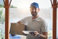 Happy delivery man, box and tablet in logistics, ecommerce or courier service at front door. Portrait of male person Royalty Free Stock Photo