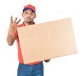 Happy delivery man carrying carton boxes showing three fingers i Royalty Free Stock Photo