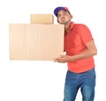 Happy delivery man carrying heavy carton boxes in uniform Royalty Free Stock Photo