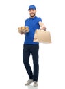 Happy delivery man with coffee and food in bag Royalty Free Stock Photo