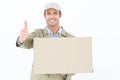 Happy delivery man gesturing thumbs up while carrying cardboard box Royalty Free Stock Photo