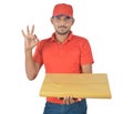 Happy delivery man holding gift pack with happy sign in uniform Royalty Free Stock Photo