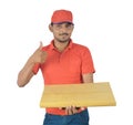 Happy delivery man holding gift pack, thumb up in uniform Royalty Free Stock Photo