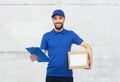 Happy delivery man with parcel box and clipboard Royalty Free Stock Photo