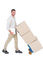 Happy delivery man pushing trolley of boxes