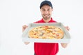 Happy delivery man showing fresh pizza Royalty Free Stock Photo