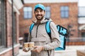 happy delivery man with thermal bag and coffee Royalty Free Stock Photo