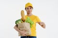 Happy delivery woman pointing at grocery bag in hand Royalty Free Stock Photo