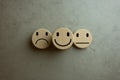 Happy, depressed and sad symbol on wood blocks. Service excellence rating for satisfaction