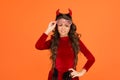 Happy devil kid with party glasses wear horns costume of imp on halloween party, halloween fun Royalty Free Stock Photo