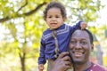 Happy devoted dad holding lifting cute little child daughter