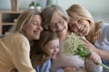 Happy grandkid woman, mature daughter, girl kid hugging elderly grandma Royalty Free Stock Photo