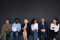 Happy different generations multiracial business people on black background.